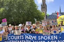 Climate protest in front of the International Court of Justice, July 2025 A group of people hold protest signs and a large banner in front of the International Court of Justice in The Hague, banner reads: "COURTS HAVE SPOKEN – GOVERNMENTS MUST ACT NOW"