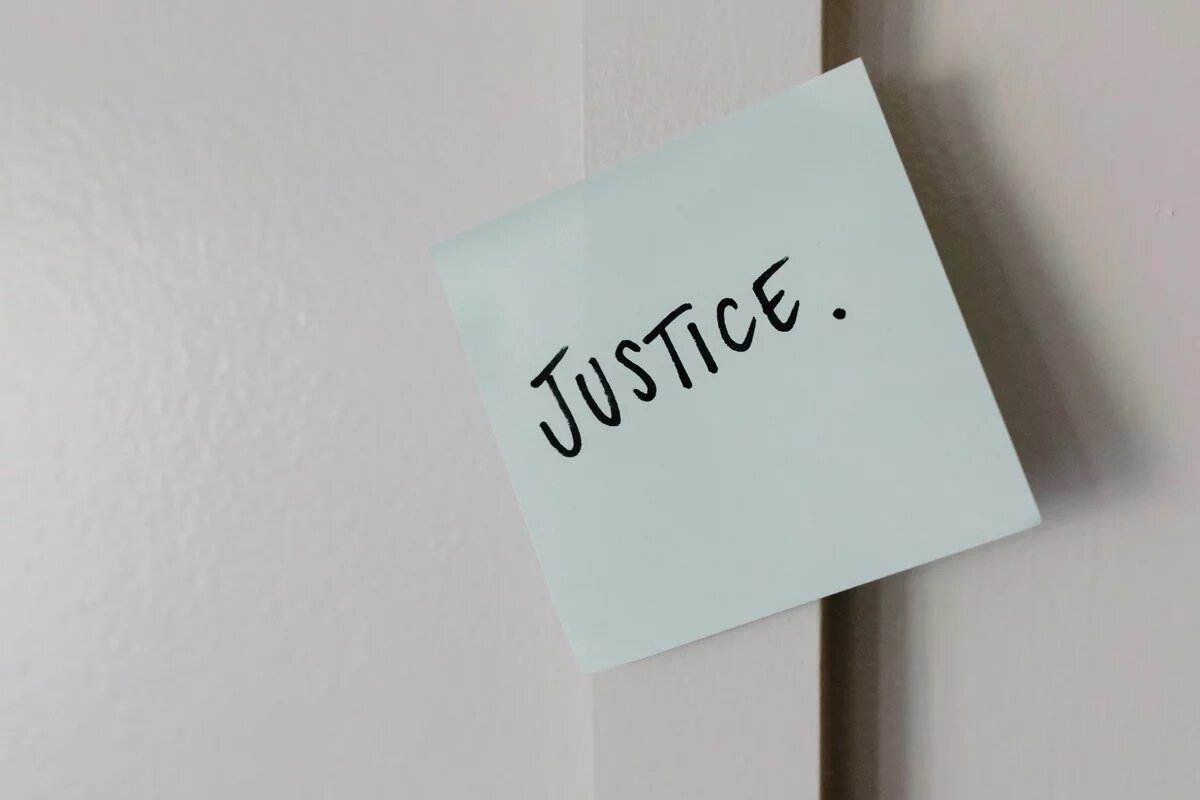 Sticky note with the word 'Justice' on it