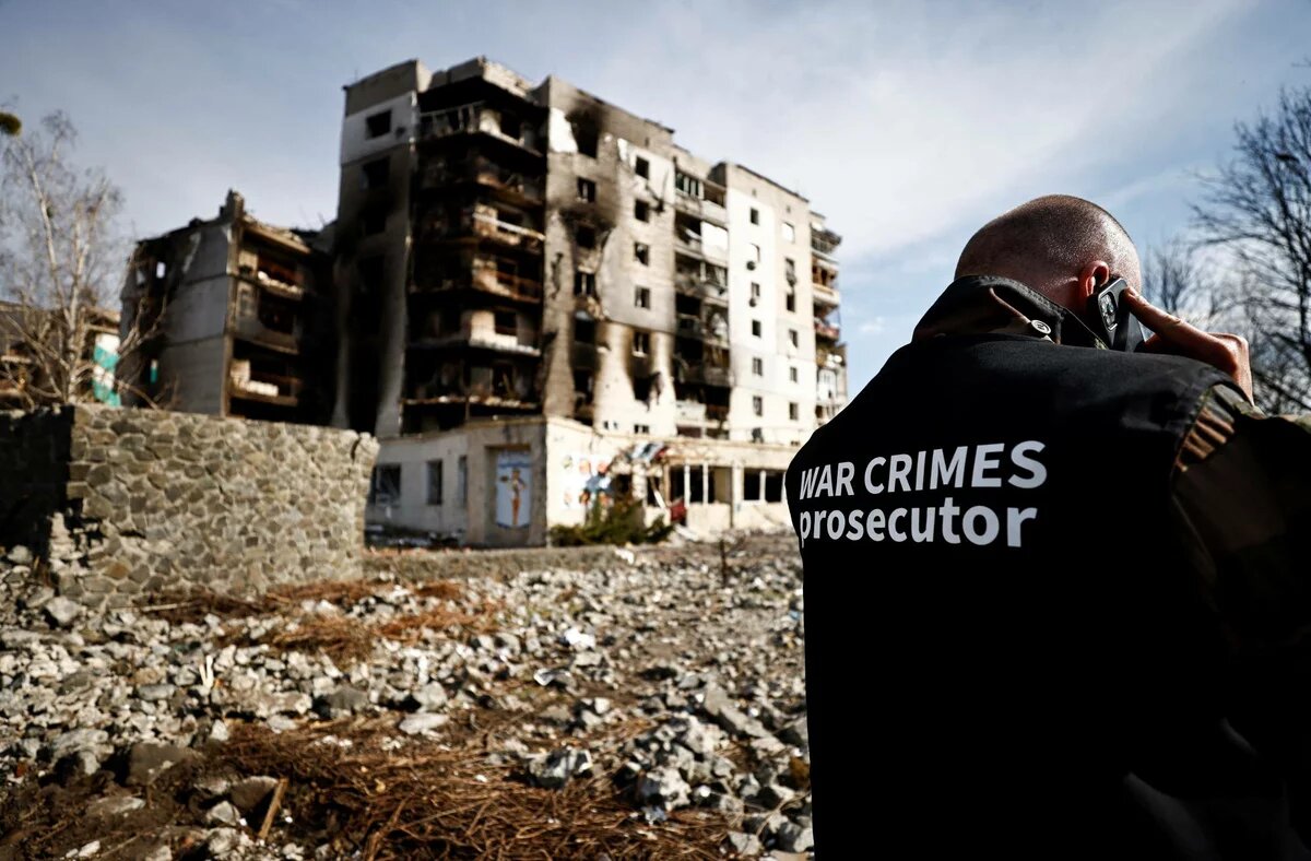 A war crimes prosecutor team inspects buildings that were destroyed by Russian shelling in Borodyanka, Ukraine, on Thursday. | REUTERS