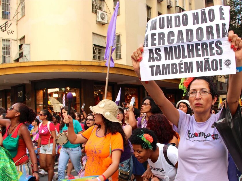 Women demonstrating in Brasilia. The message on the placard says: "The world isn't a commodity, so aren't women"