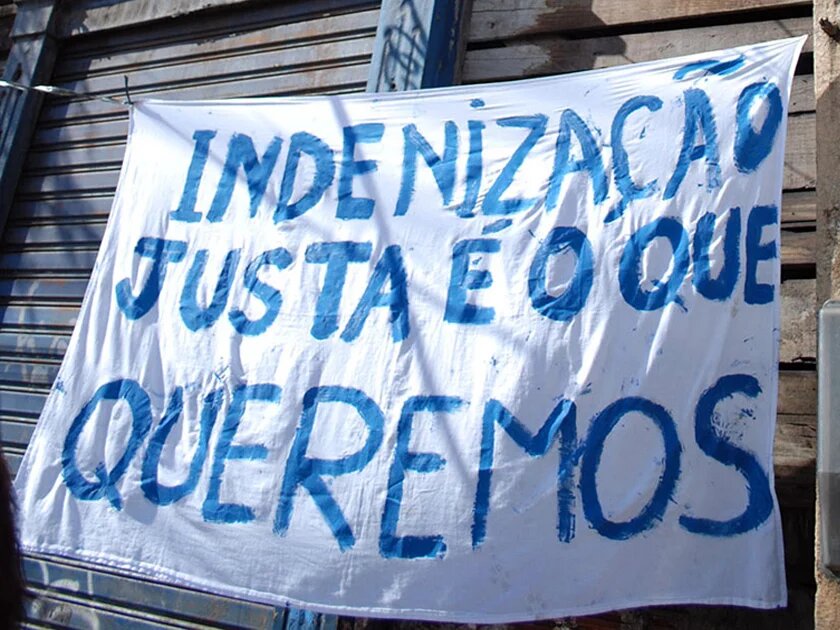 "We want fair compensation payments" this notice says in the neighbourhood of Campinho in the North of Rio de Janeiro "We want fair compensation payments" this notice says in the neighbourhood of Campinho in the North of Rio de Janeiro
